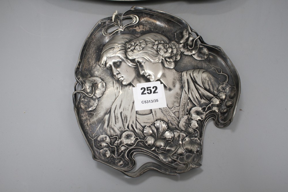 A WMF pewter tray, decorated with two maidens, 23cm, and another tray decorated with Diana hunting a stag, 41cm